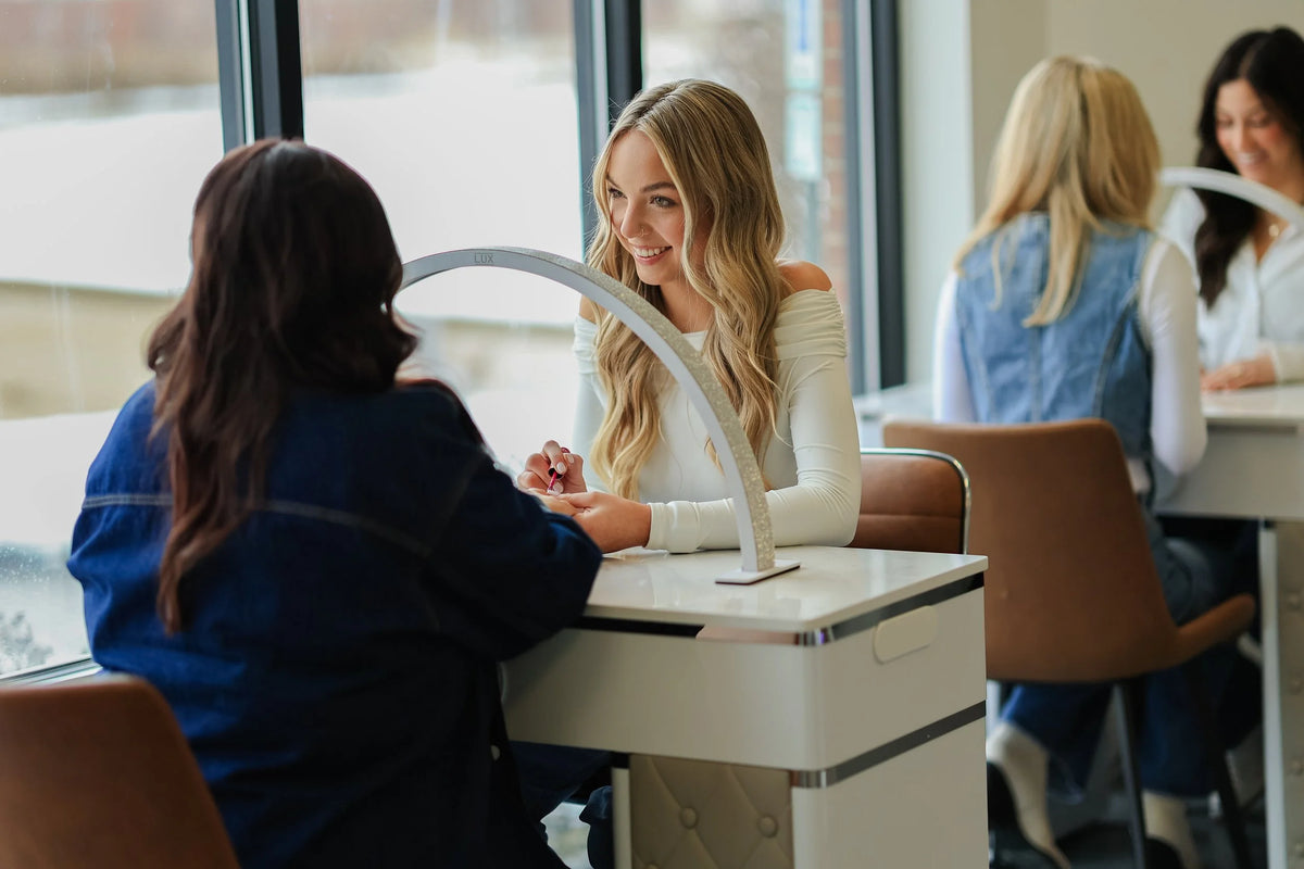 A nail technician and a guest at a manicure table at Oh Baby Salon and Spa in Bloomington, Illinois