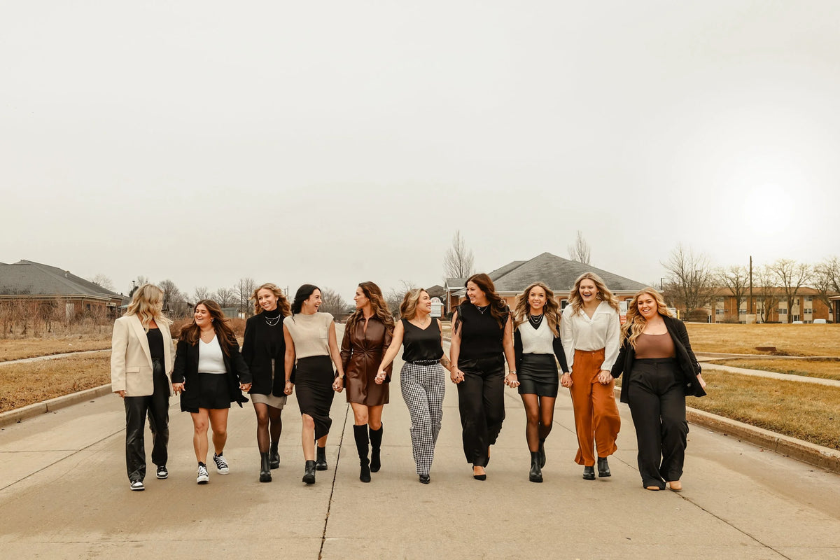 A group of women walking together outdoors near Oh Baby Salon and Spa in Bloomington, Illinois