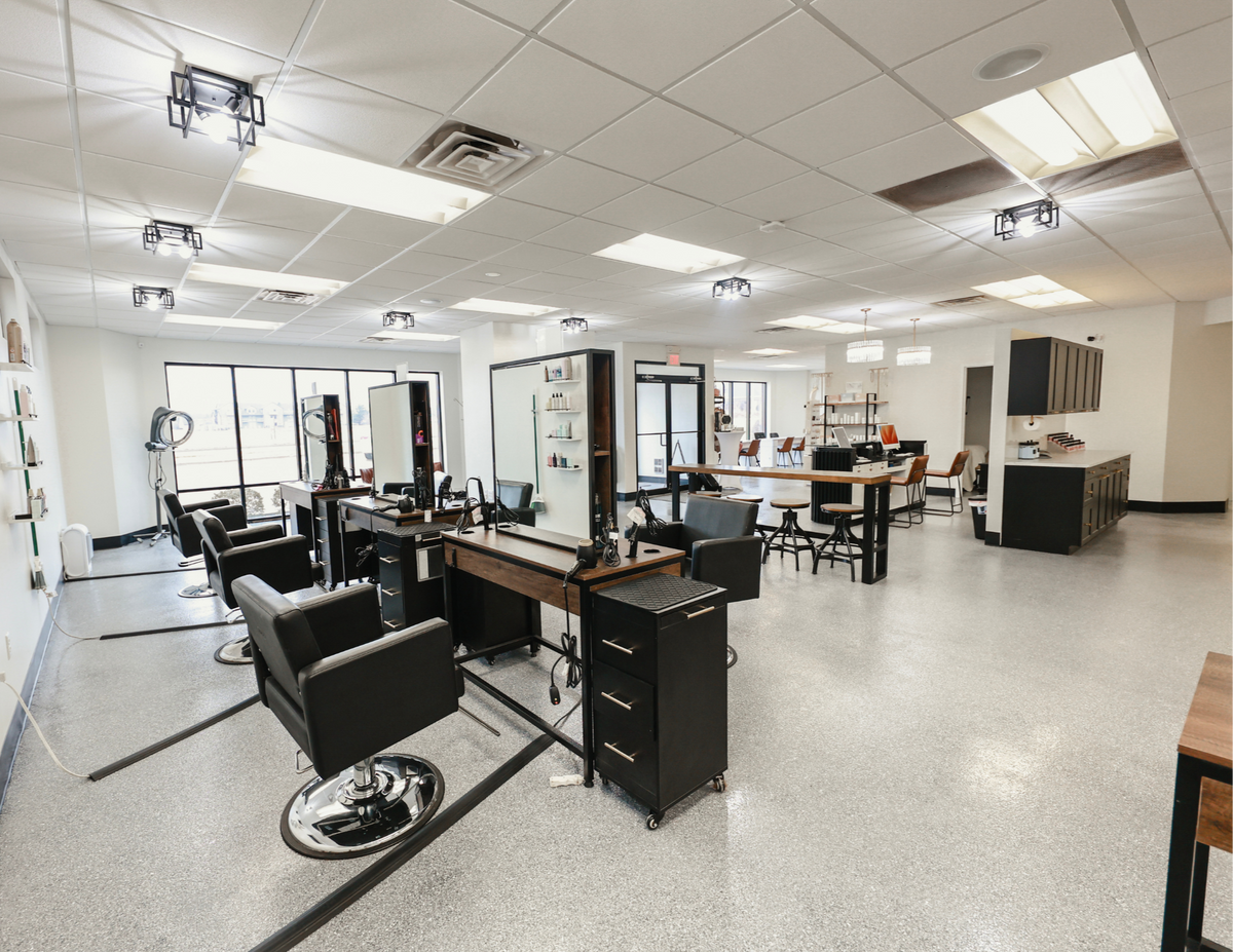 Salon floor with styling chairs, mirrors, and workstations at Oh Baby Salon and Spa in Bloomington, Illinois